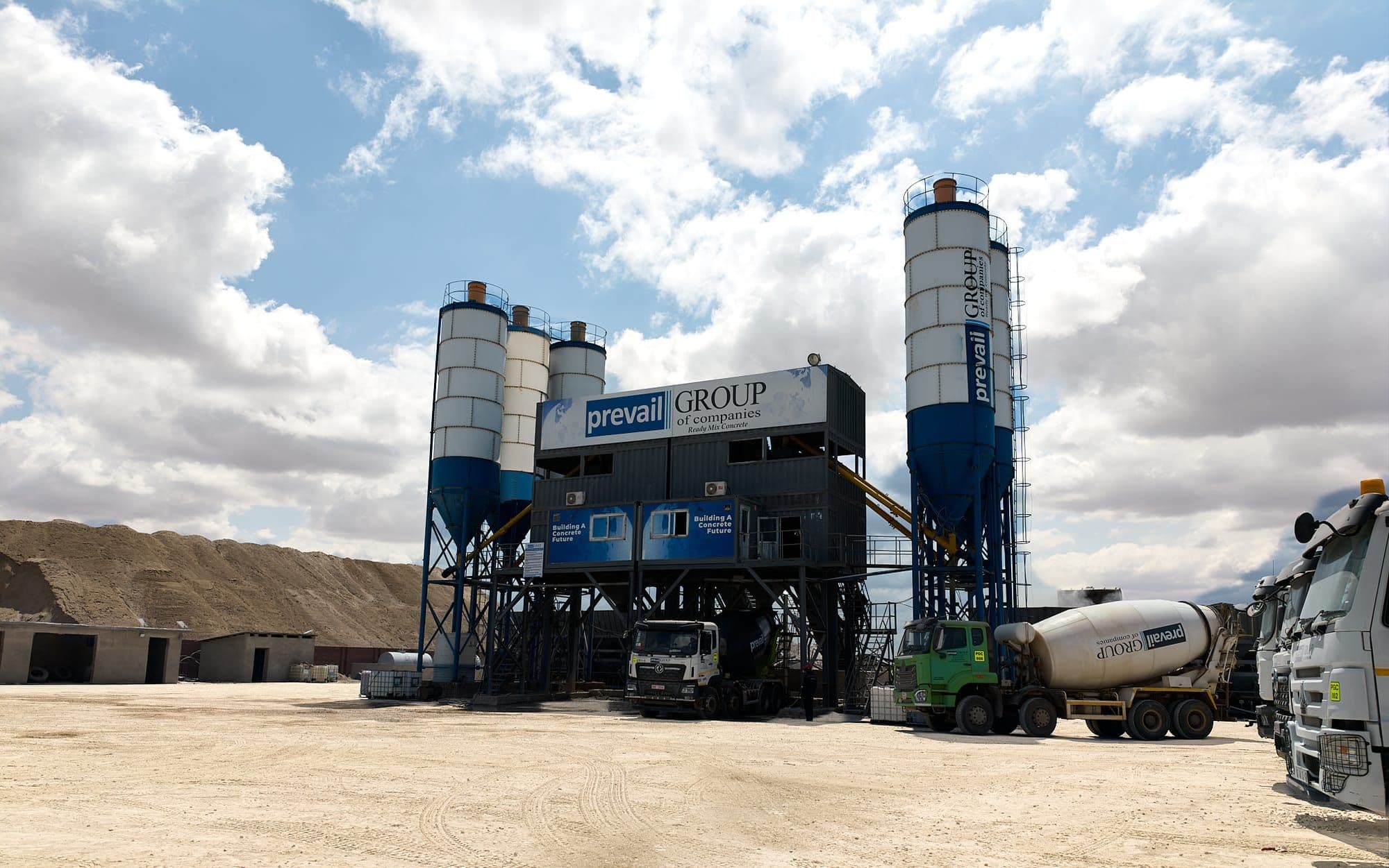 Prevail Concrete batching plant with transit mixers loading in the yard